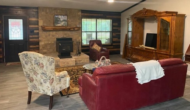 Large, open format farmhouse set back with 100 acres of prime hunting/fishing.