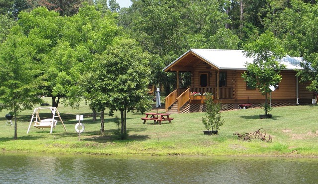Log cabin overlooking a private lake on a working farm